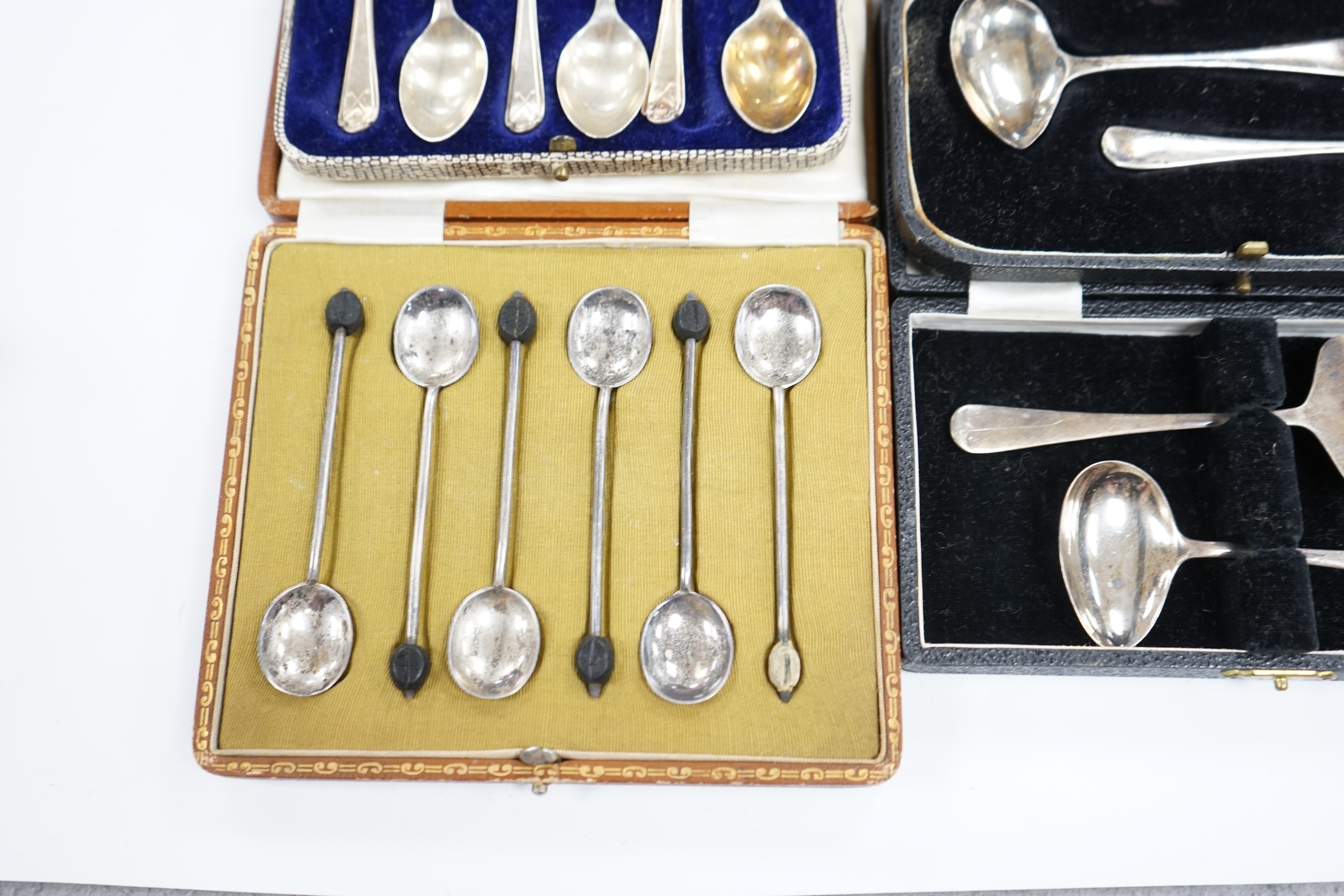 Two cased sets of six silver coffee spoons including bean end and golfing related and two cased silver christening spoons and pushers. Condition - poor to fair